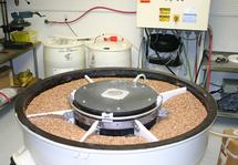 Vibratory Processing Machine, filled with high density non-abrasive ceramic polishing media