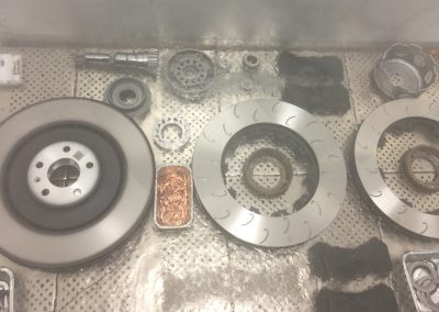 Assortment of high performance automotive brake rotors, pads, & miscellaneous.